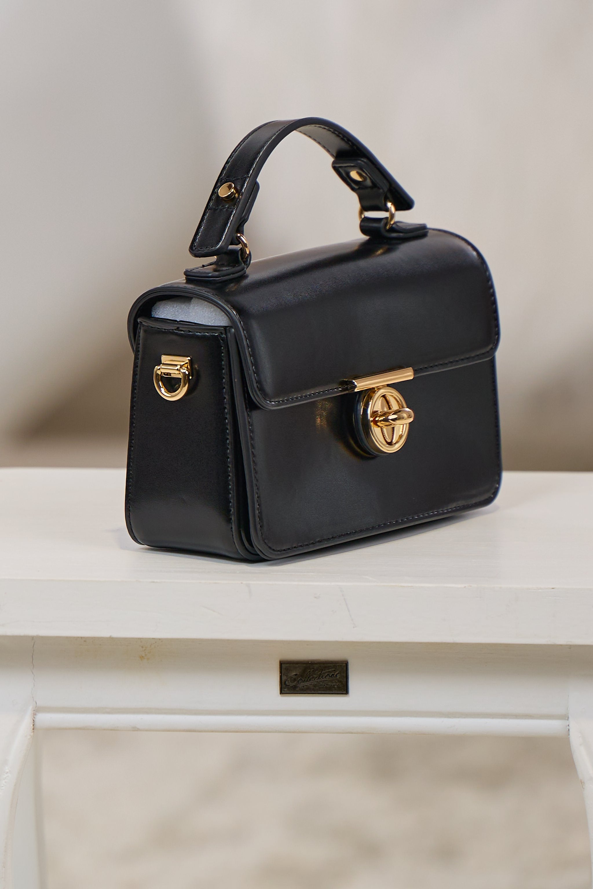 elegante Tasche mit Drehverschluss, schwarz-gold