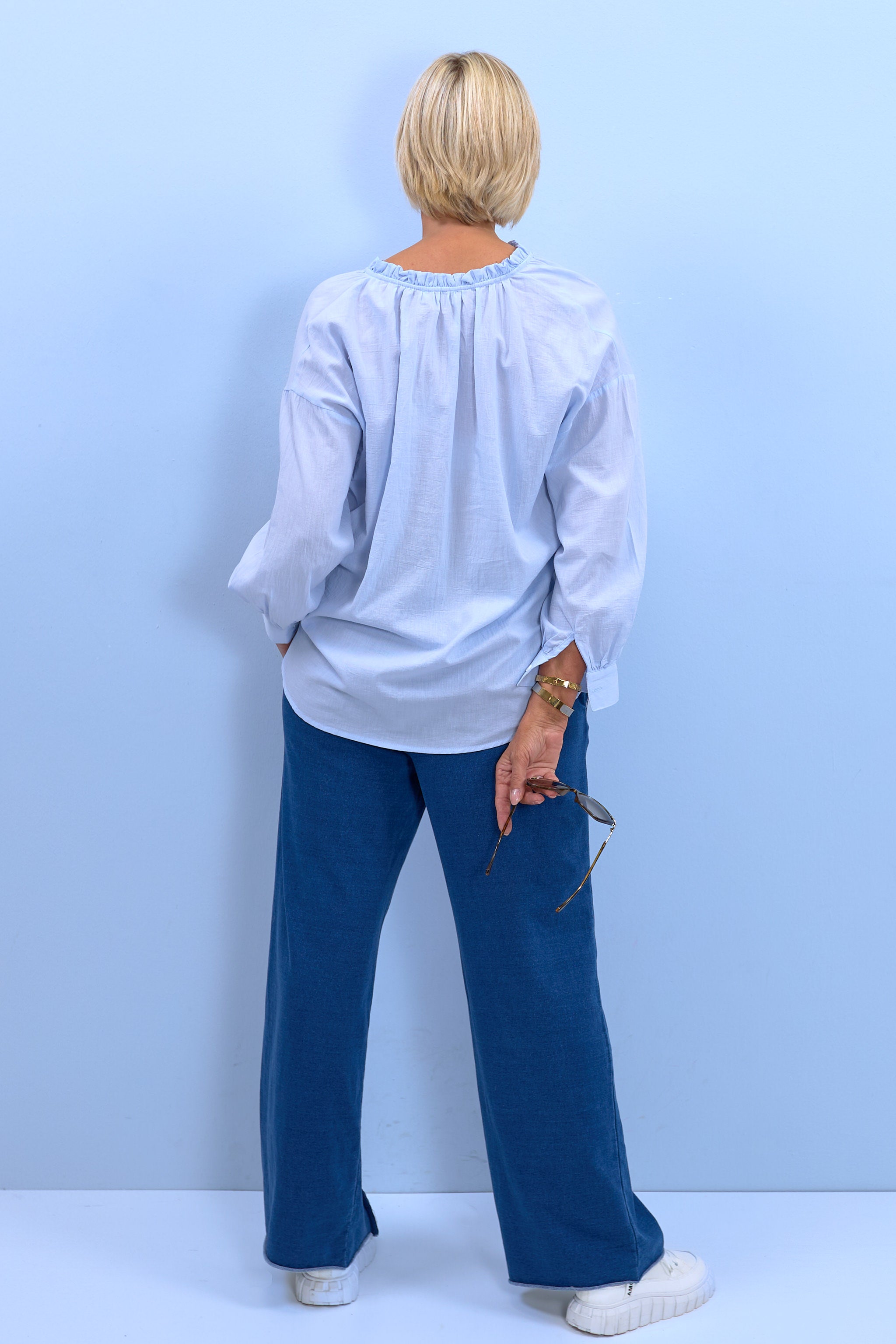Blouse with a small ruffle at the neckline, light blue