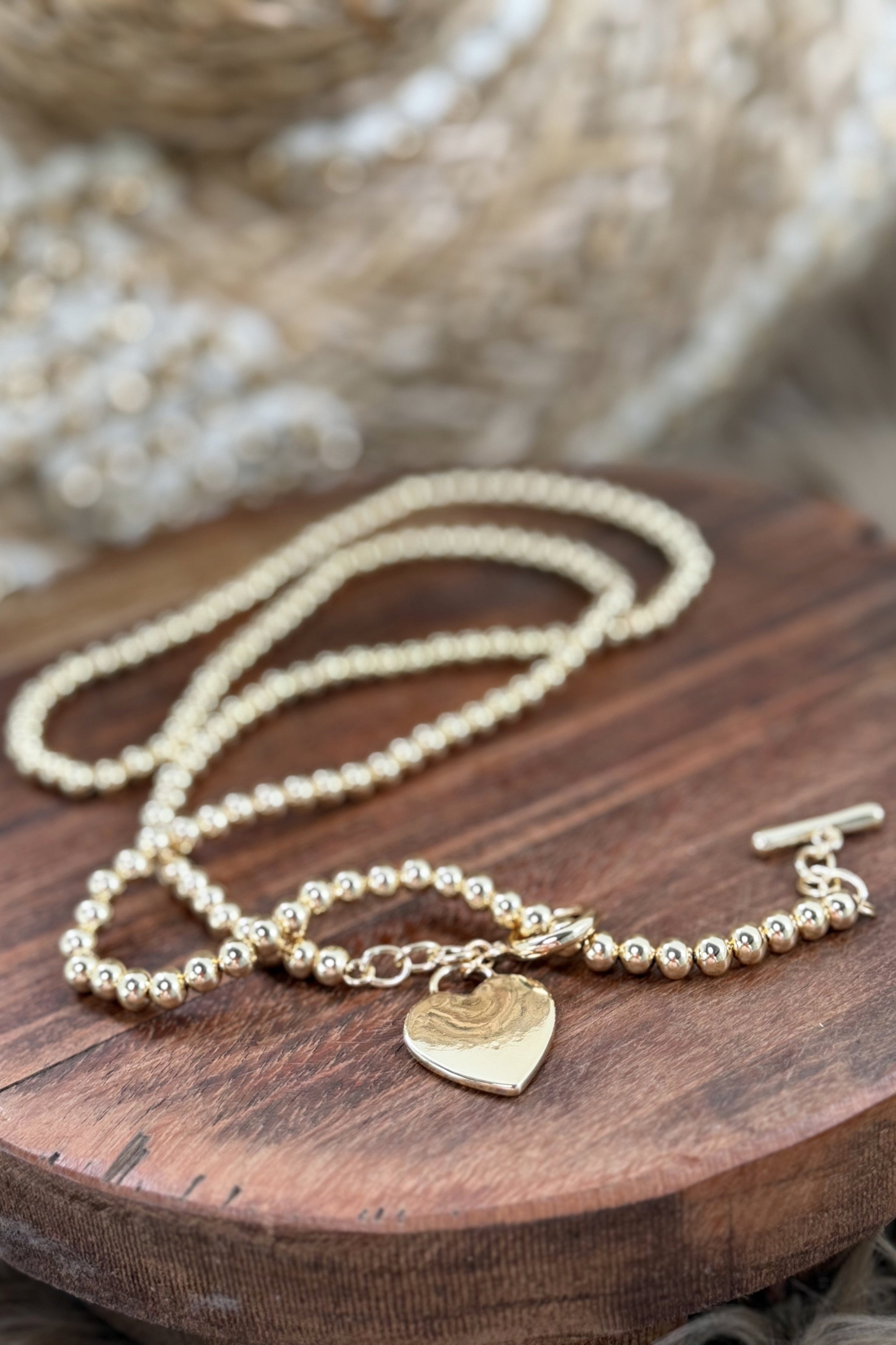 Long pearl necklace with a heart, gold