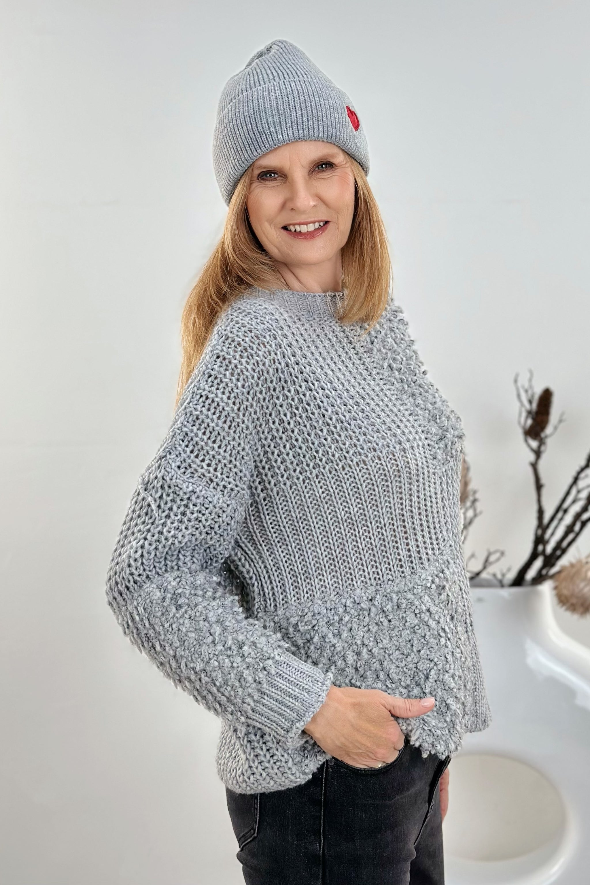 Knitted sweater with boucle and patent pattern, grey